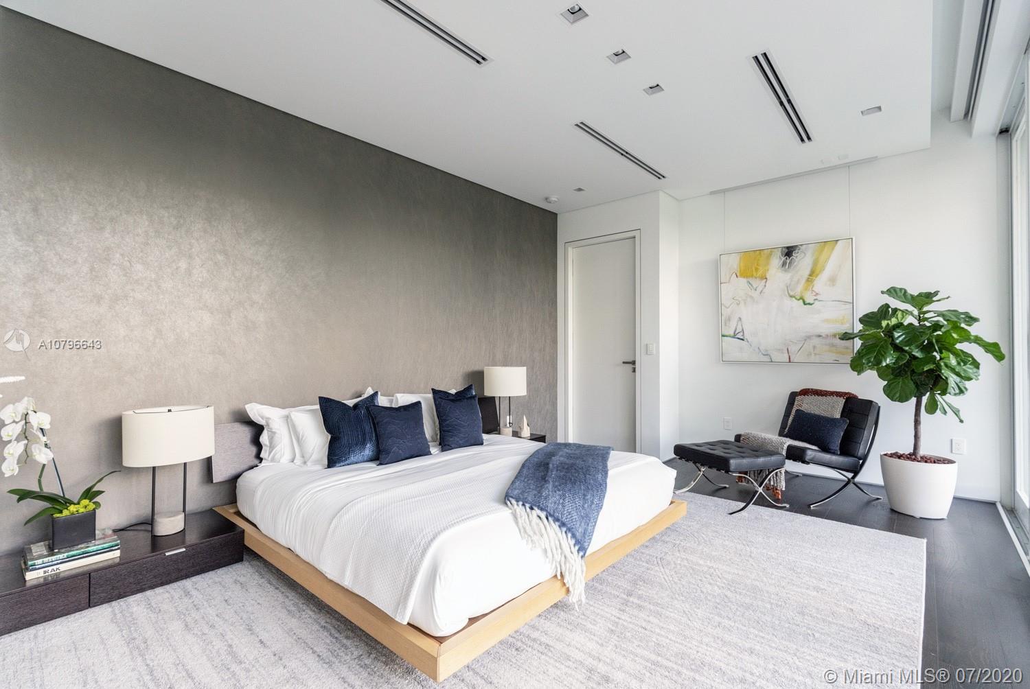 4731 Lake Road Miami, FL 33137 - Photo 27 of 46 a bedroom with a bed and a potted plant on the dresser