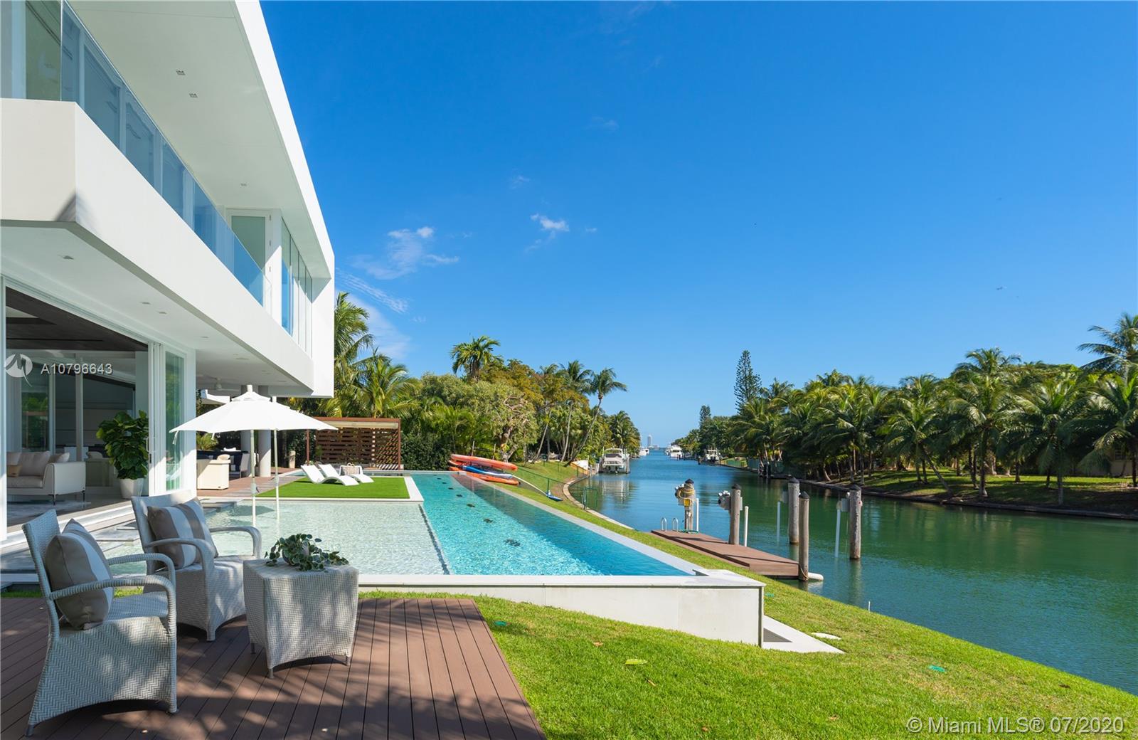 4731 Lake Road Miami, FL 33137 - Photo 44 of 46 a view of swimming pool with seating area and trees in the background