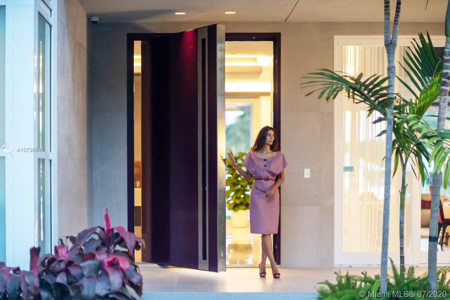 4731 Lake Road Miami, FL 33137 - Photo 8 of 46 a vase of flowers sitting on a floor in front of a door