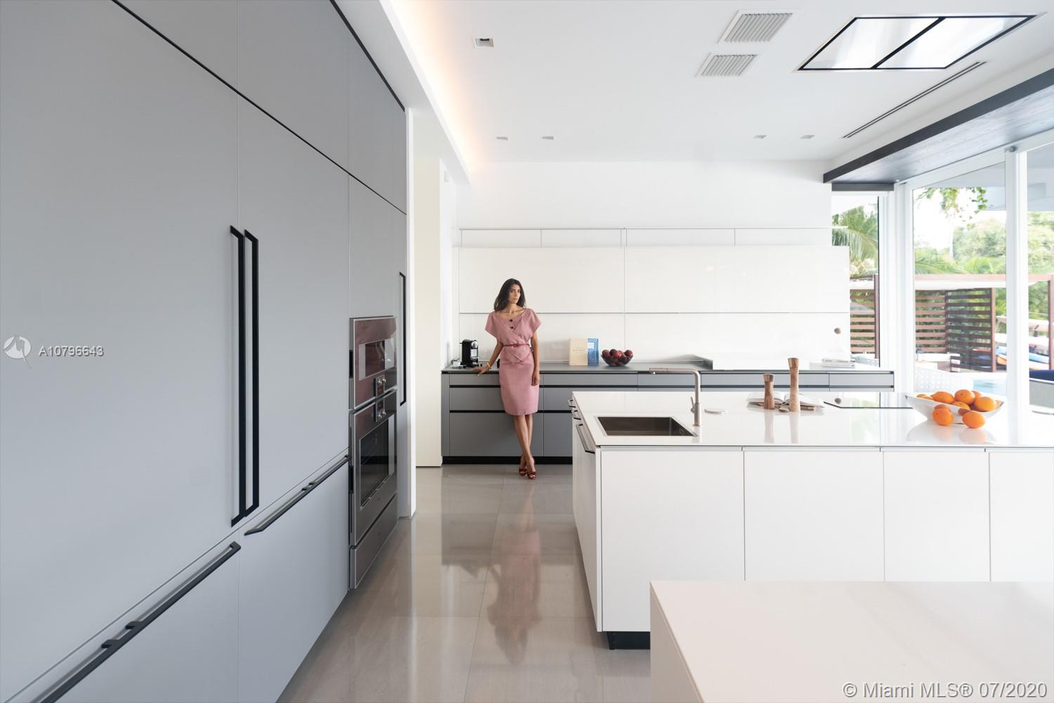 4731 Lake Road Miami, FL 33137 - Photo 10 of 46 a kitchen with a sink and a refrigerator
