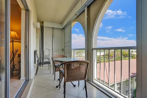 a view of a balcony with furniture and a potted plant