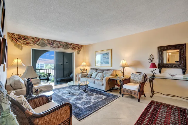 a living room with furniture and a lamp