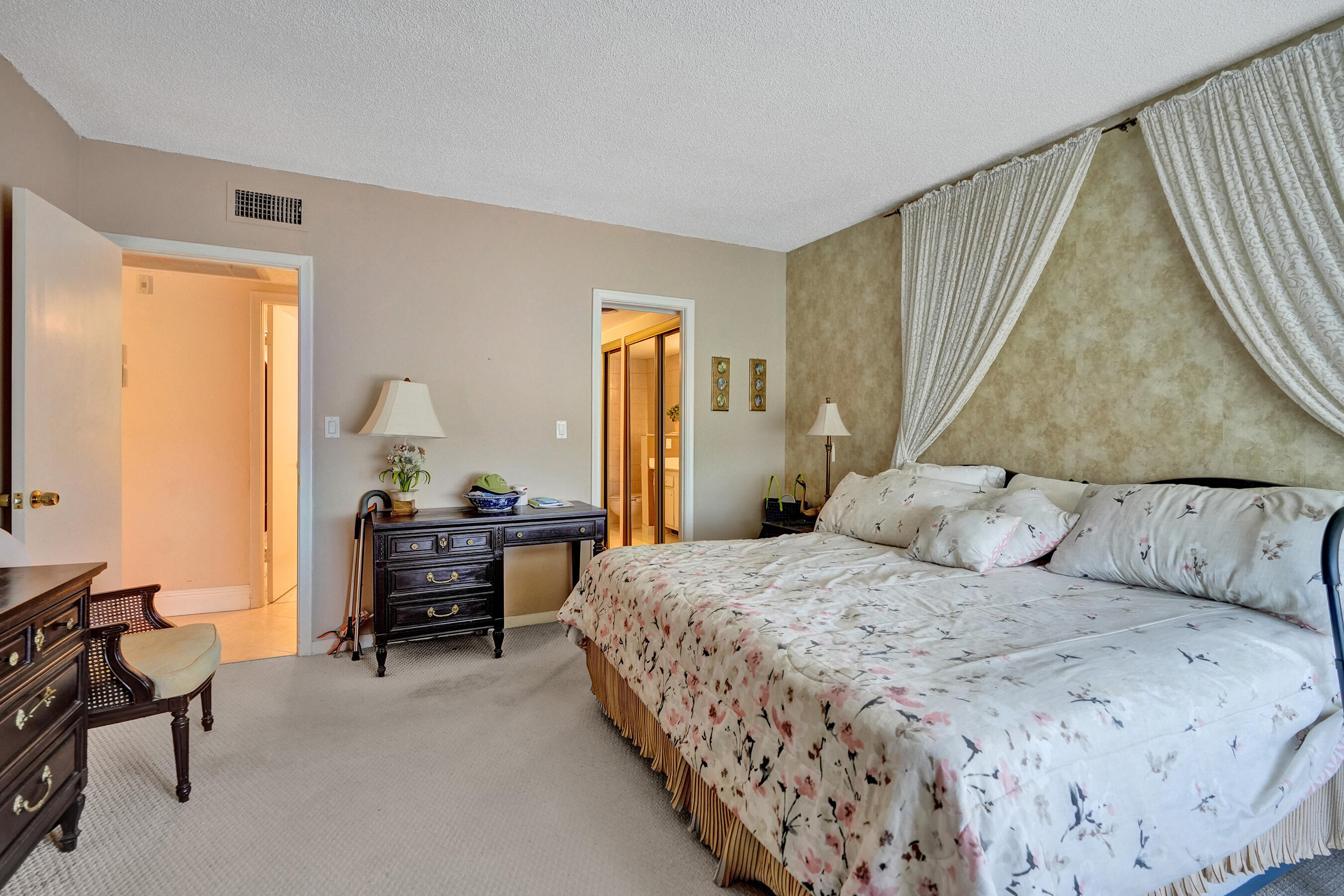 250 Northeast 20th Street, Unit 5060 Boca Raton, FL 33431 - Photo 36 of 36 a bedroom with a bed and a chandelier