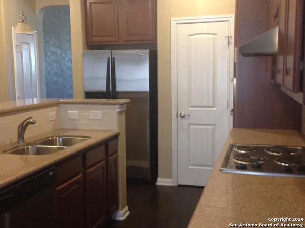 a kitchen with a sink and a refrigerator