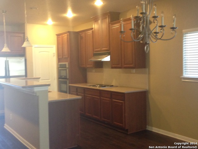 157 Lone Star Boerne, TX 78006 - Photo 6 of 19 a kitchen with stainless steel appliances granite countertop a sink and a cabinets