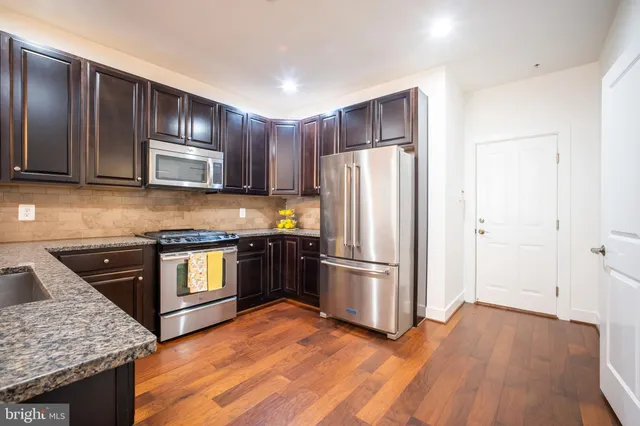a view of a dining room with furniture and wooden floor