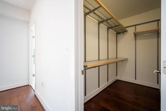 a bedroom with bed and wooden floor