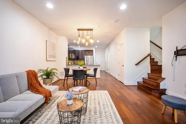 a living room with furniture and kitchen view