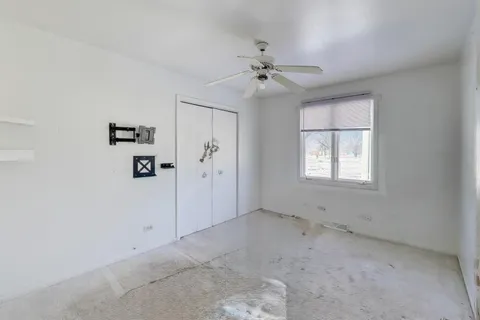 a view of empty room with wooden floor and window
