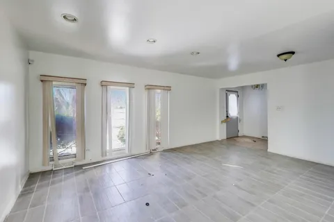 a view of a kitchen with a sink and a refrigerator