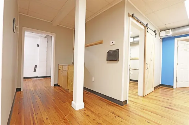 a view of a hallway with wooden floor