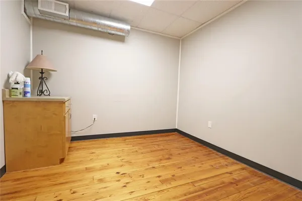 a view of a room with wooden floor