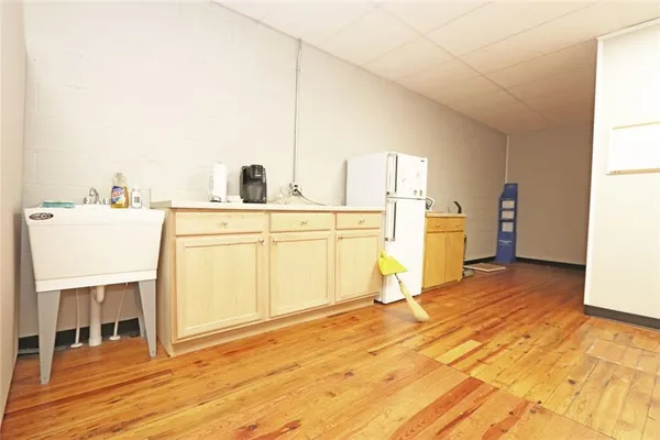 a view of kitchen and hall with wooden floor