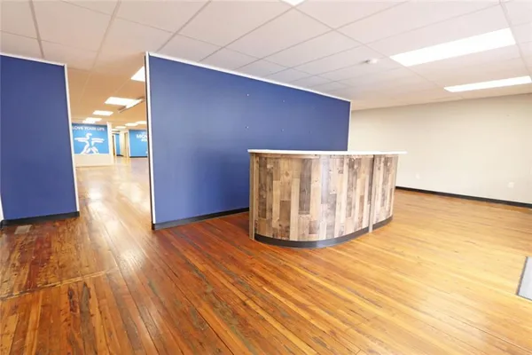 a view of an empty room with wooden floor