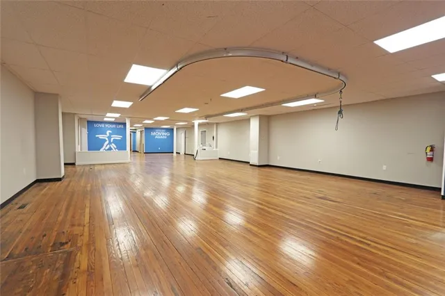 a view of a room with wooden floor