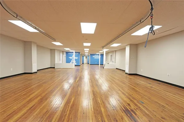 a view of a room with wooden floor