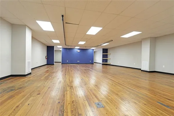 a view of a room with wooden floor