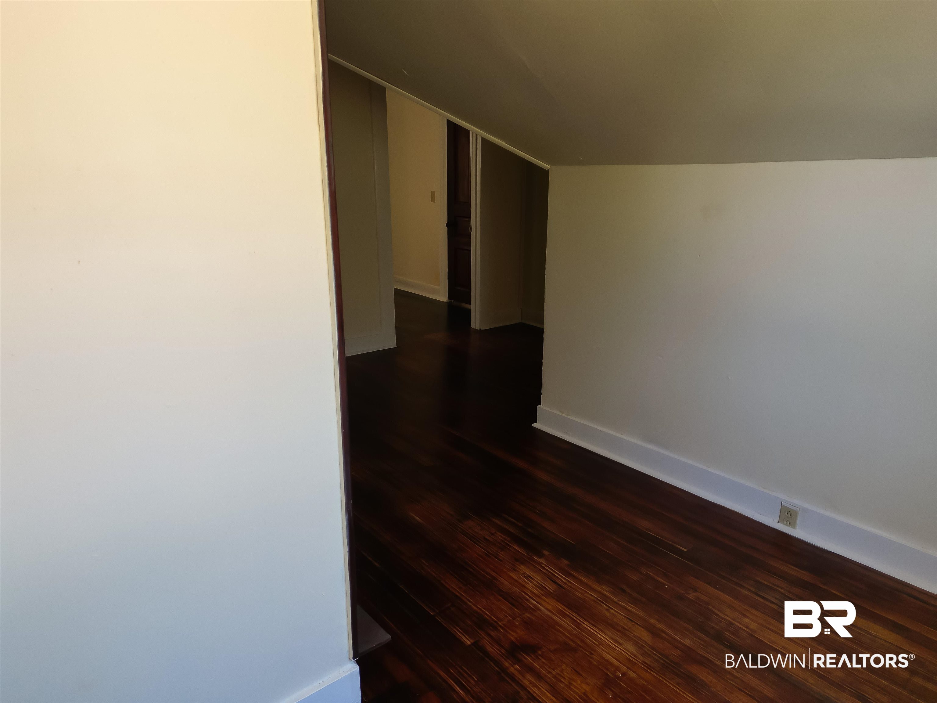 73 Liberty Street Monroeville, AL 36460 - Photo 17 of 29 Hall featuring lofted ceiling and dark hardwood / wood-style flooring