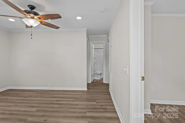 a view of a hallway with wooden floor