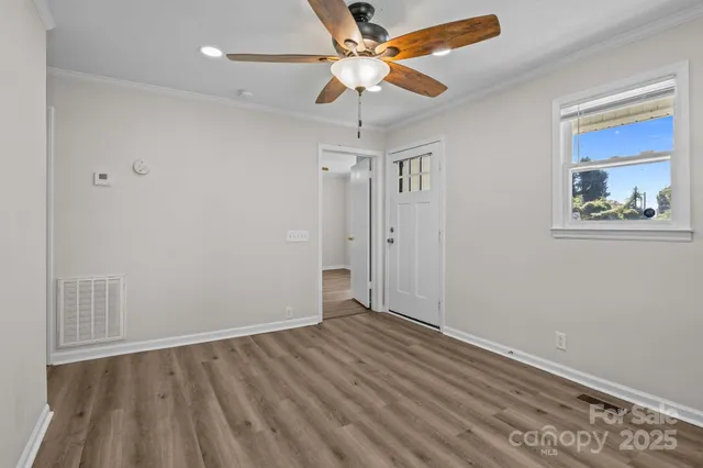 a view of an empty room with a window