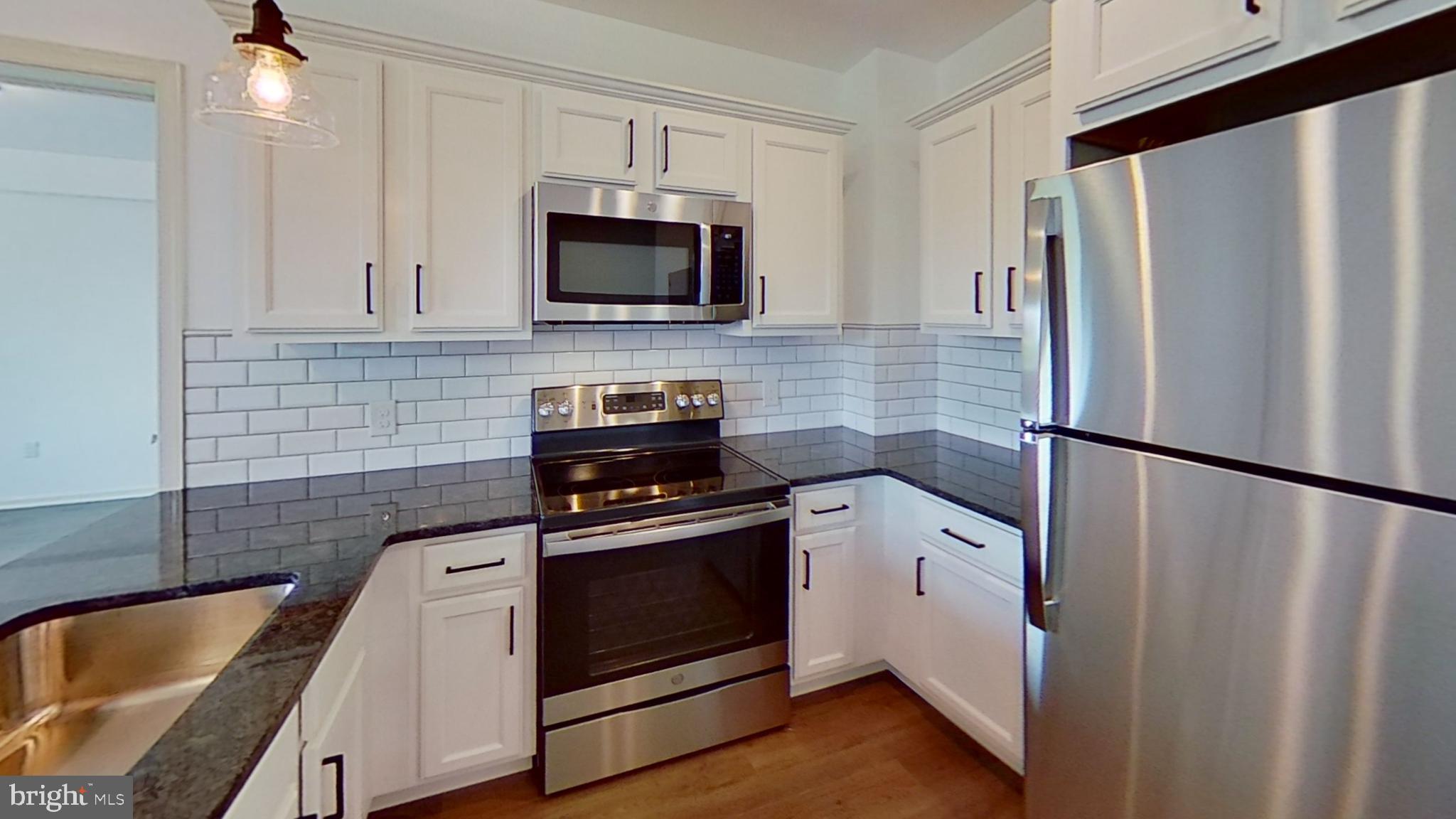 a kitchen with a refrigerator sink and stove
