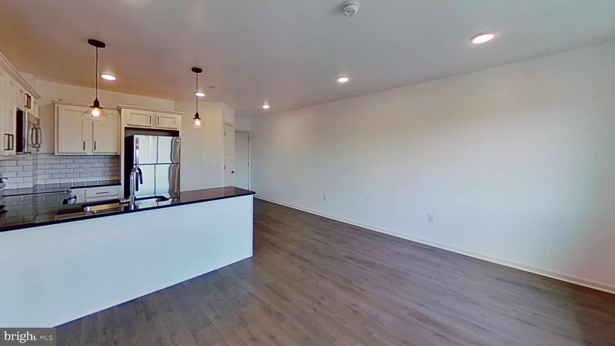 6778 Ridge Avenue, Unit 205 Philadelphia, PA 19128 - Photo 3 of 7 a living room with stainless steel appliances wooden floors and view living room