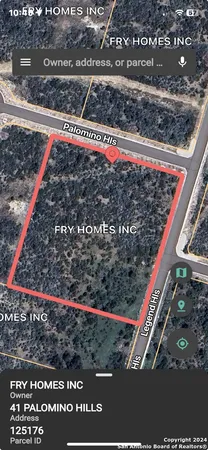 a view of a street with wooden fence