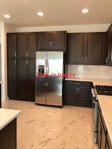 a stove top oven sitting inside of a kitchen