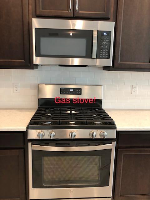 11670 Southwest Sailfish Isles Way Port St. Lucie, FL 34987 - Photo 12 of 25 a stove top oven sitting inside of a kitchen