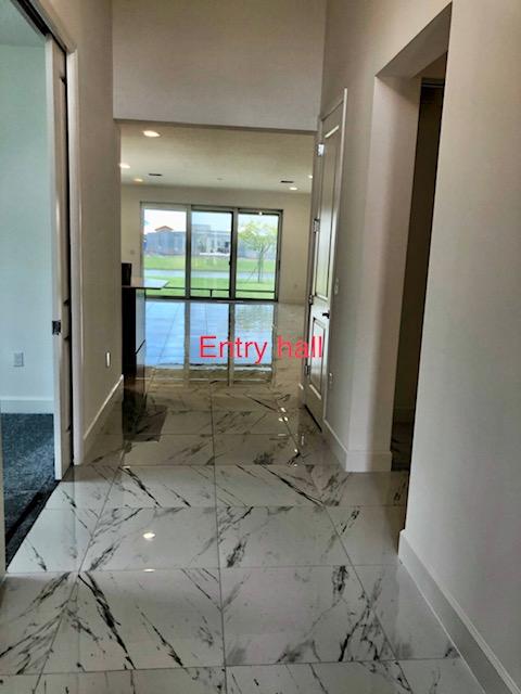 11670 Southwest Sailfish Isles Way Port St. Lucie, FL 34987 - Photo 14 of 25 a view of a hallway with windows