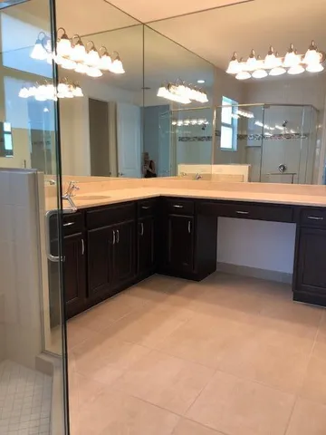 a bathroom with a granite countertop toilet sink and bathtub