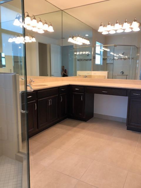 11670 Southwest Sailfish Isles Way Port St. Lucie, FL 34987 - Photo 18 of 25 a large bathroom with a sink and a large mirror
