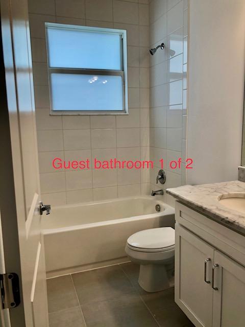 11670 Southwest Sailfish Isles Way Port St. Lucie, FL 34987 - Photo 20 of 25 a bathroom with a granite countertop toilet sink and bathtub