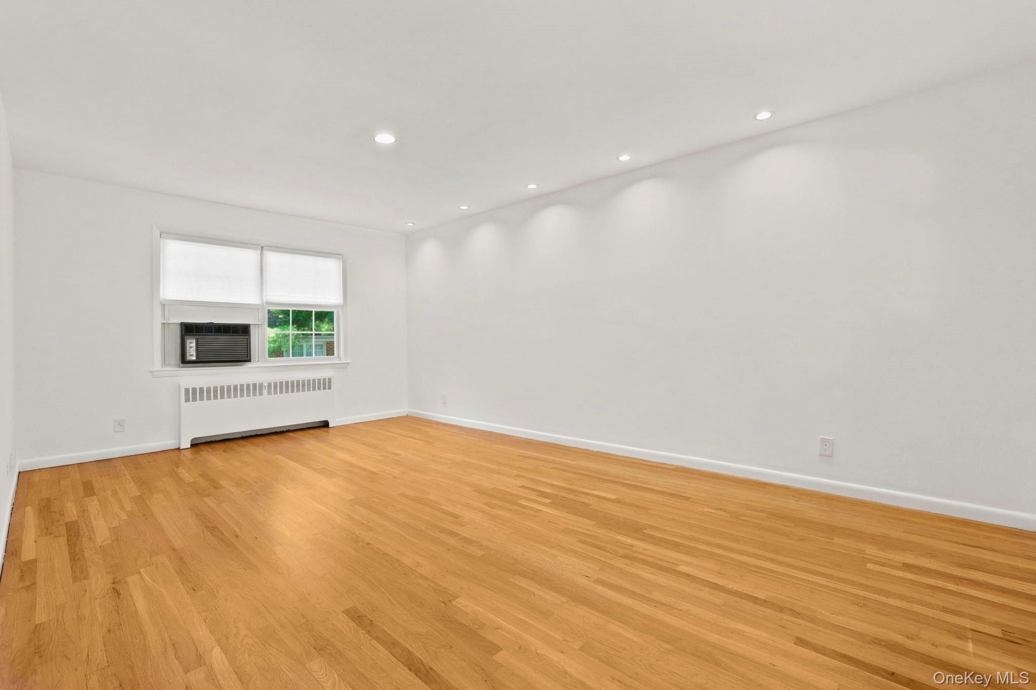 186 Pinewood Road, Unit 56 Hartsdale, NY 10530 - Photo 5 of 29 The living room has recess lighting and tree-top views from the windows on both the north and south side