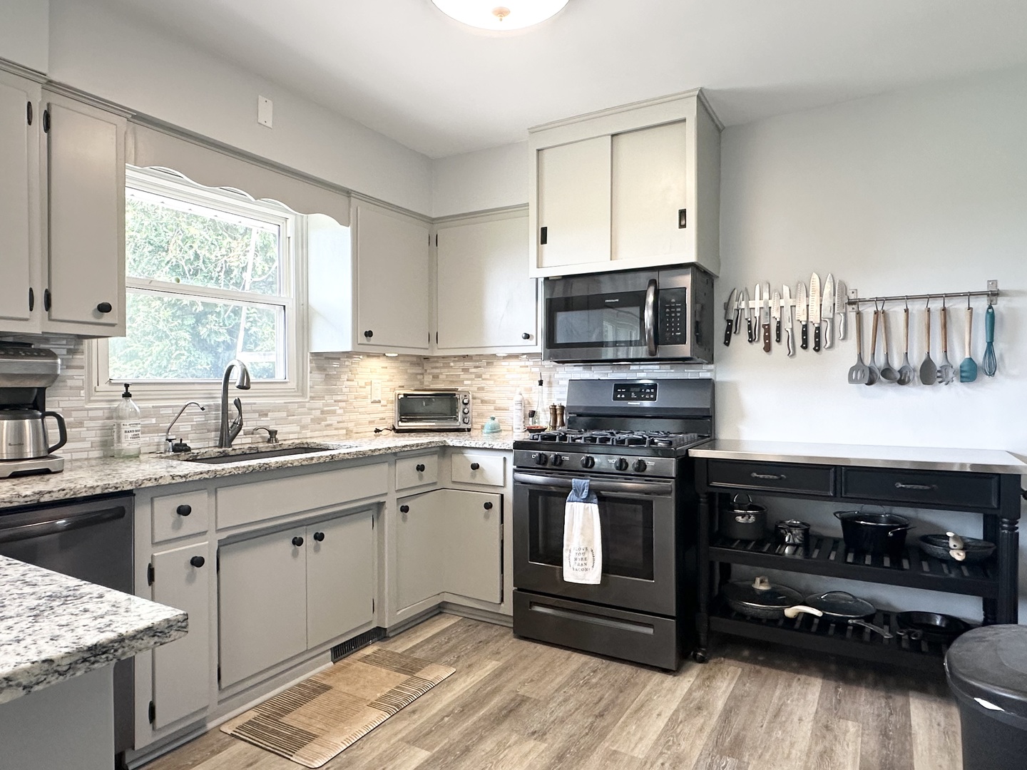3150 River Road Kankakee, IL 60901 - Photo 7 of 40 a kitchen with stainless steel appliances a stove a sink a stove and a microwave