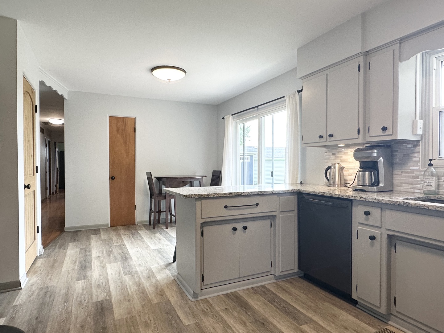 3150 River Road Kankakee, IL 60901 - Photo 9 of 40 a kitchen with granite countertop a sink cabinets and wooden floor
