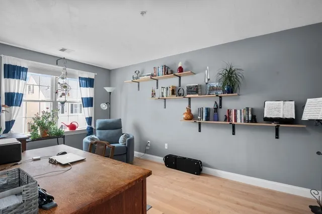 a bedroom with furniture and a wooden floor
