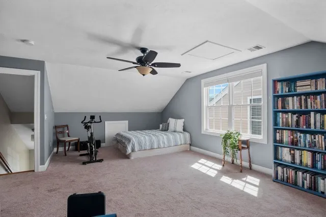 a living room with furniture and a book shelf