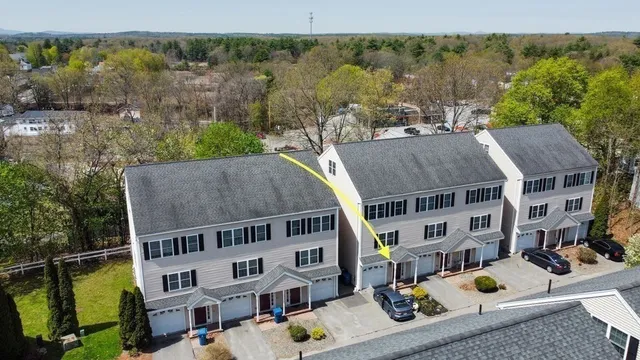 an aerial view of multiple houses with a yard