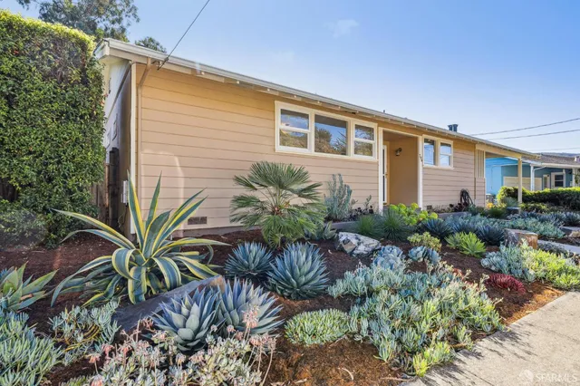 a front view of house with small garden