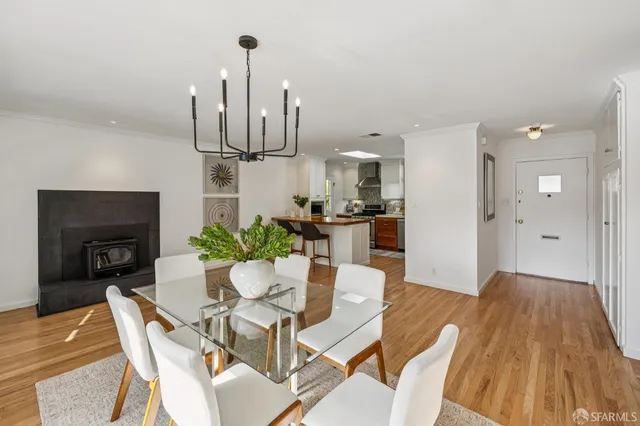 a view of a dining room with furniture wooden floor and a chandelier