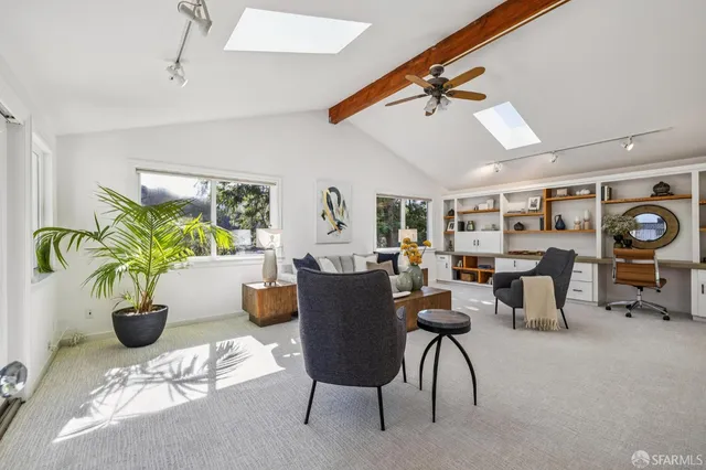 a living room with furniture and a potted plant