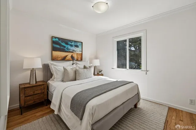 a bedroom with a bed and a night stand