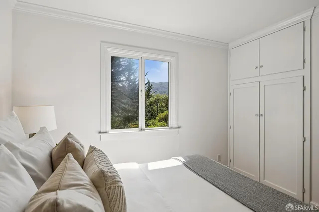 a bed room with a bed and a window