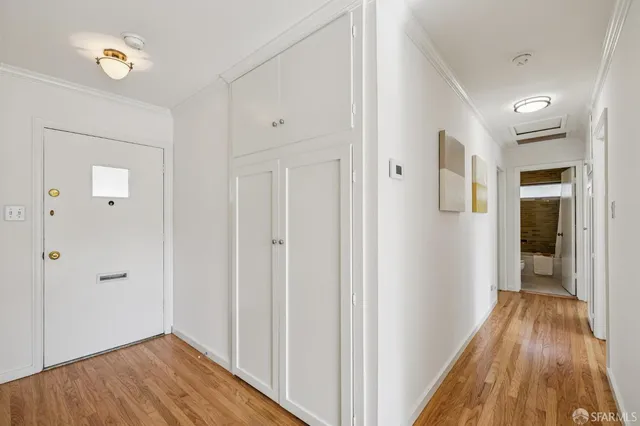 a view of a hallway with wooden floor