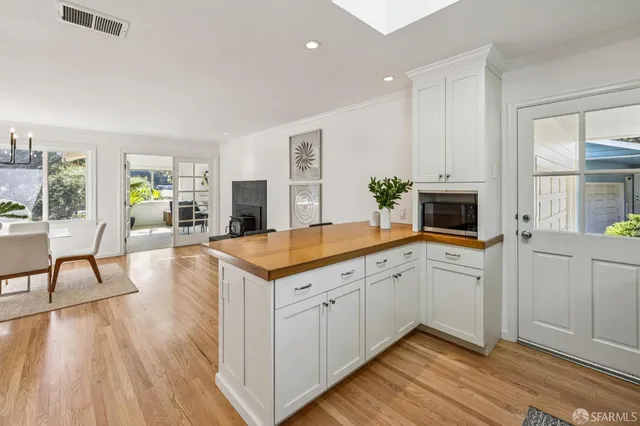 a view of a kitchen counter space wooden floor and windows
