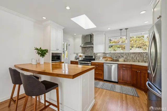 a kitchen with stainless steel appliances kitchen island granite countertop a sink and cabinets