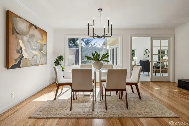 a dining room with furniture a rug and wooden floor