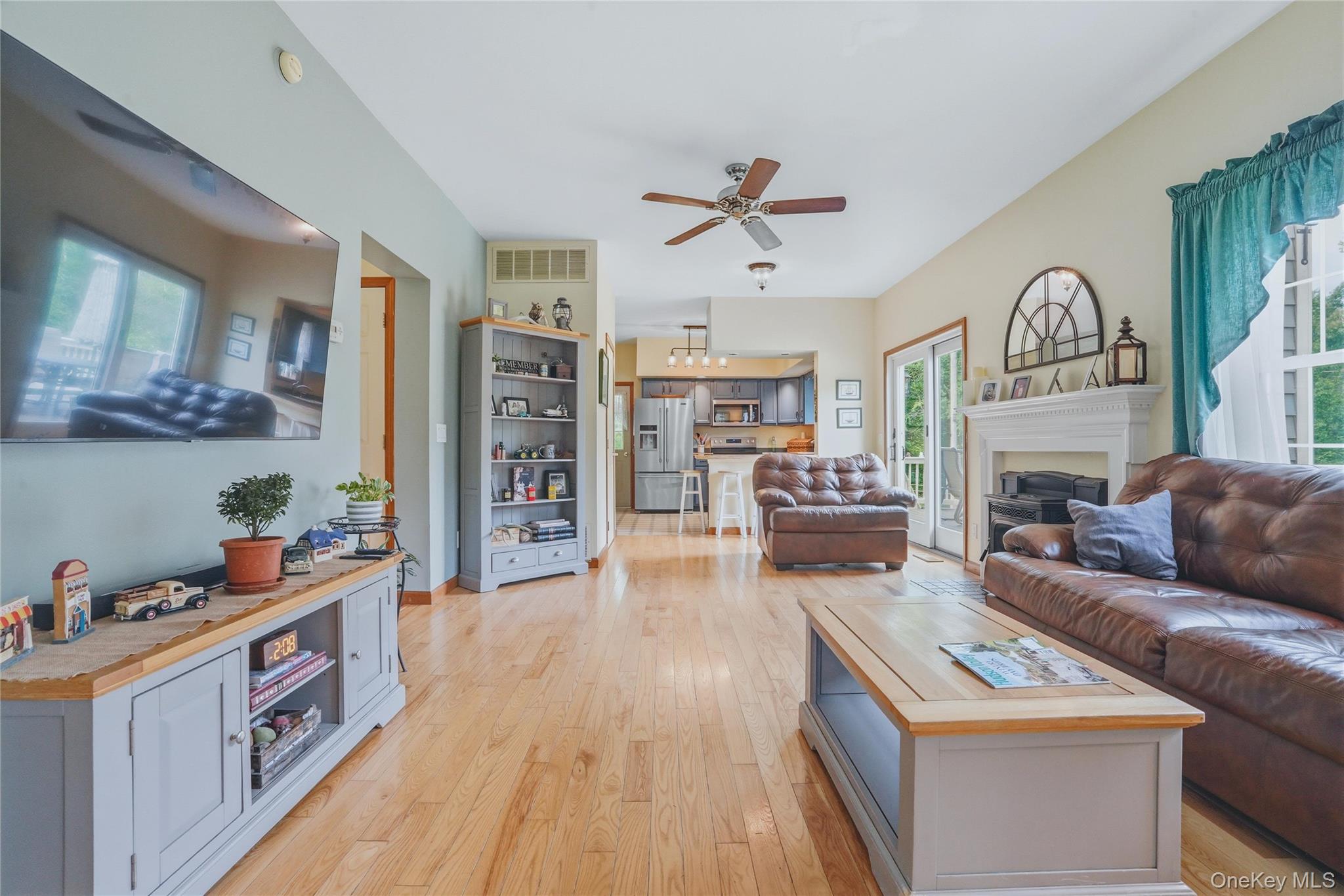 226 Cart Road, Unit C Dover Plains, NY 12522 - Photo 18 of 47 Open living room to kitchen with fireplace and wood floors