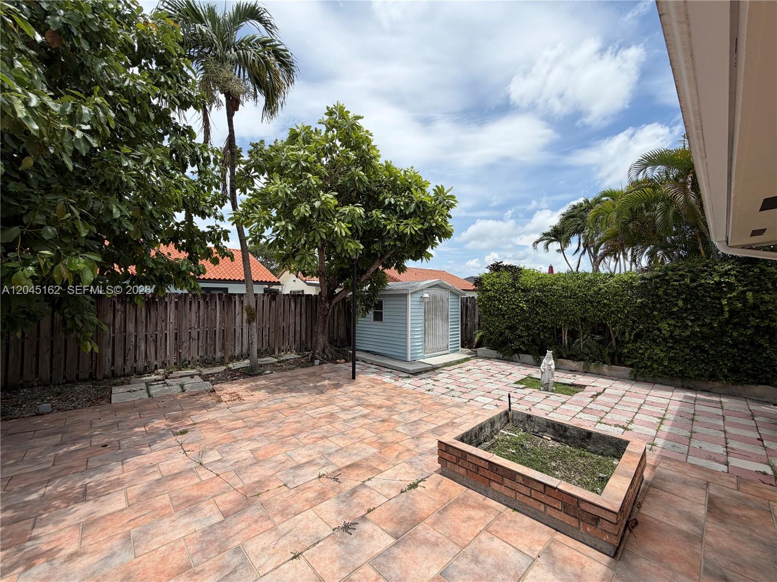 3262 Southwest 139th Place Miami, FL 33175 - Photo 33 of 36 a backyard of a house with table and chairs